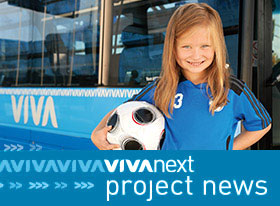 Girl posing with soccer ball under her arm; viva bus is in the background - viva next project news