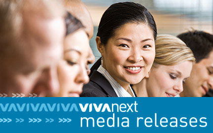 Woman smiling in focus with colleagues on either side of her out of focus - viva next media releases
