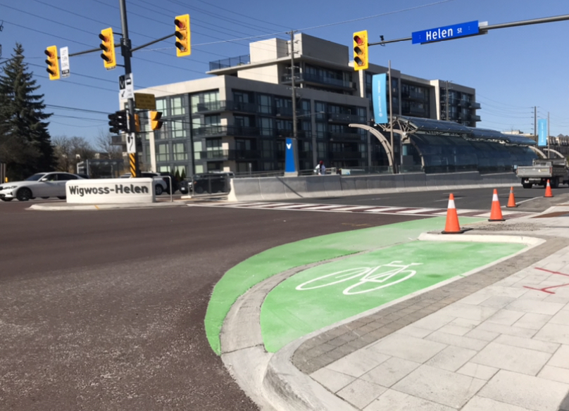 green bike box at signalized intersection waiting zone for cyclists